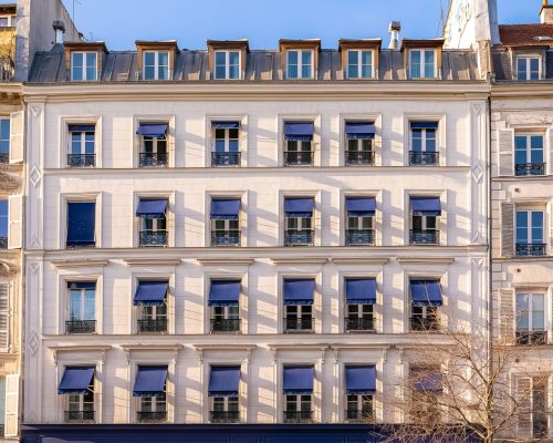 Paris, typical facade in the Marais, detail of the windows